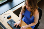 Professional woman typing at a computer